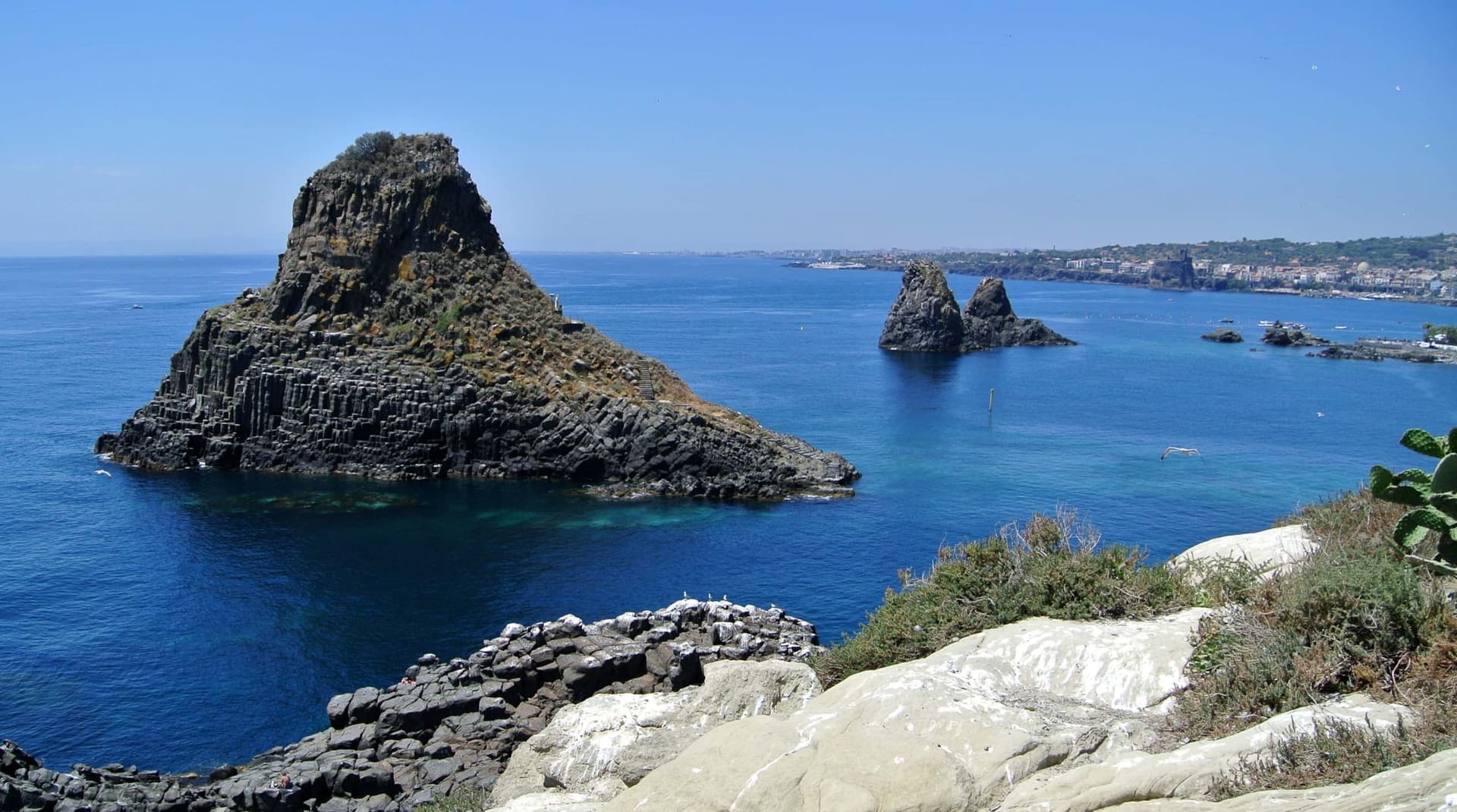 Large rocks soaring toward the sky on the coast of Sicily.